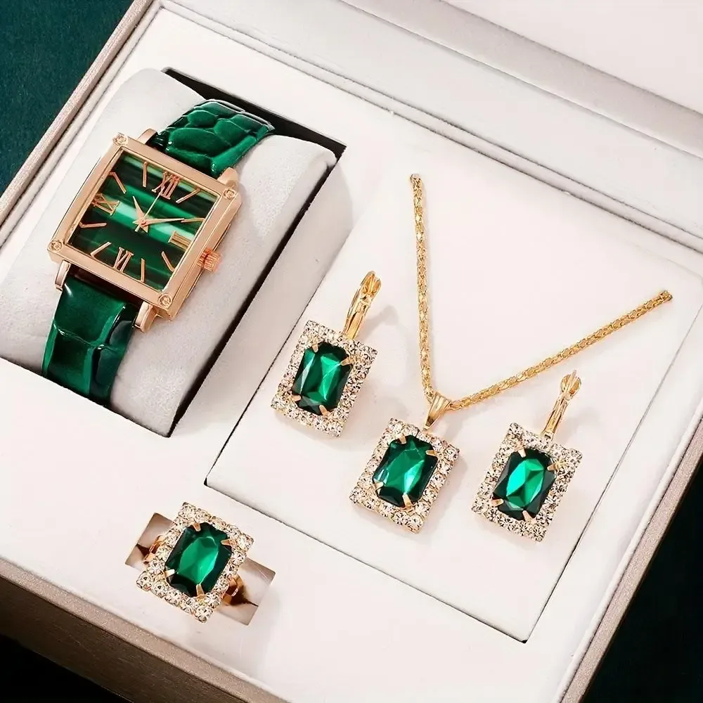 green stones framed in rhinestones on the necklace, earrings and ring