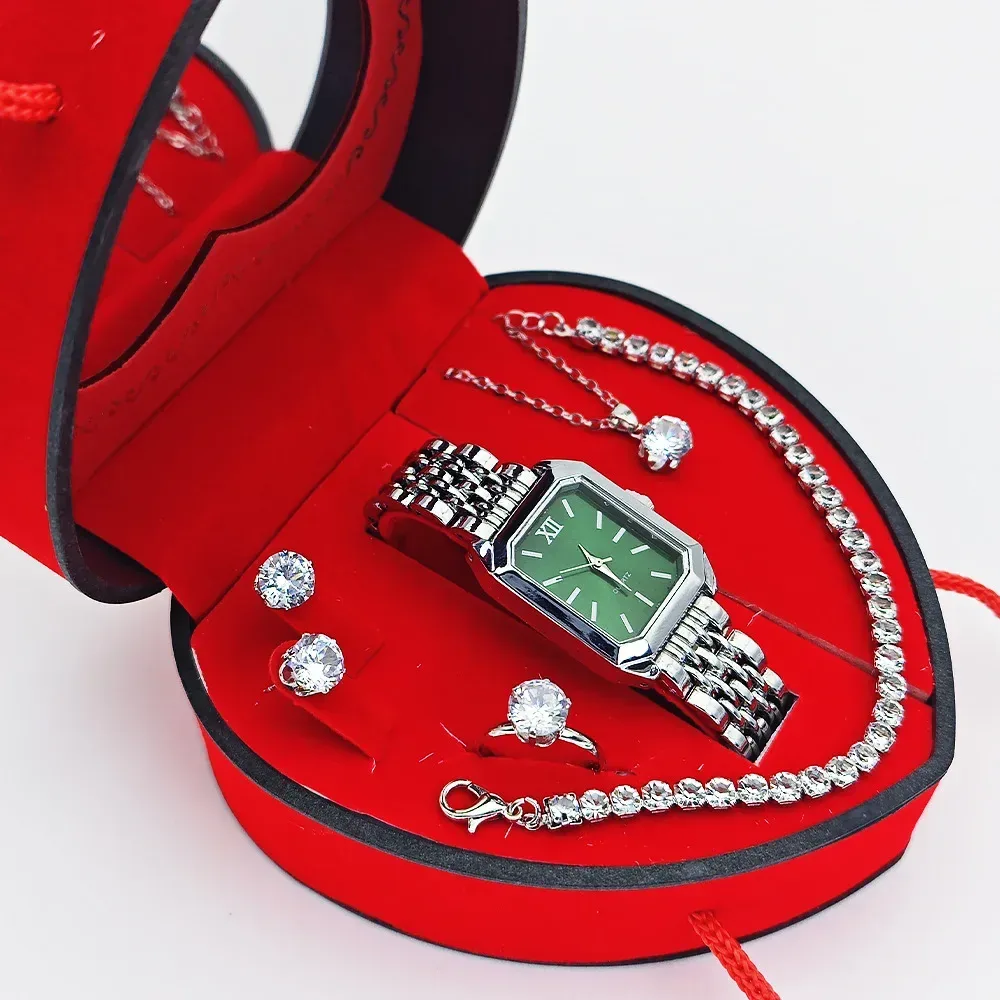 silver tone watch with green dial and rhinestone line bracelet in heart box