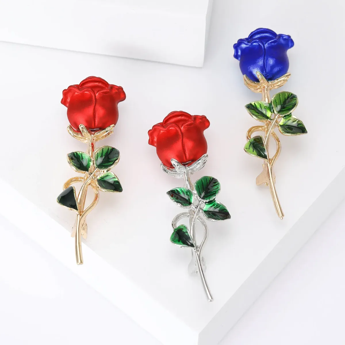red and blue long stem rose brooches