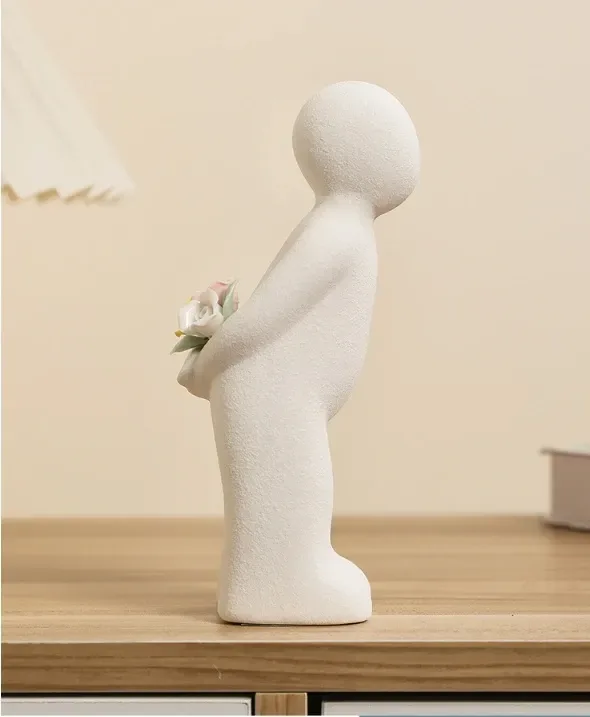 the male ceramic figurine hiding roses behind his back