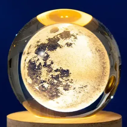 engraved moon glowing warm white inside the crystal ball night light