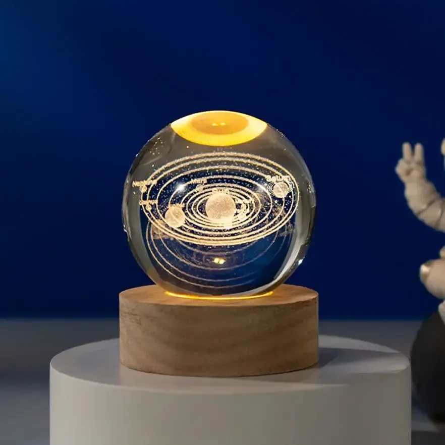 solar system crystal ball night light glowing on a shelf