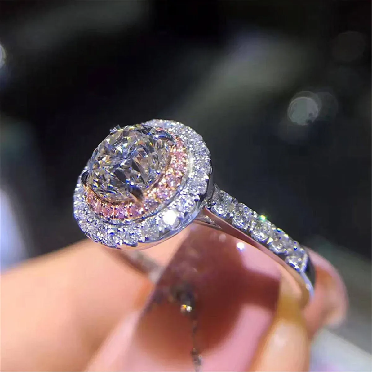 small cubic zirconia stones set along the band of the halo ring