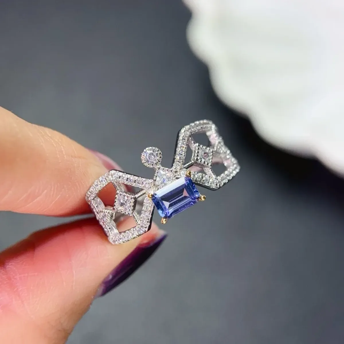 emerald cut tanzanite of 4 x 6 mm held in claws