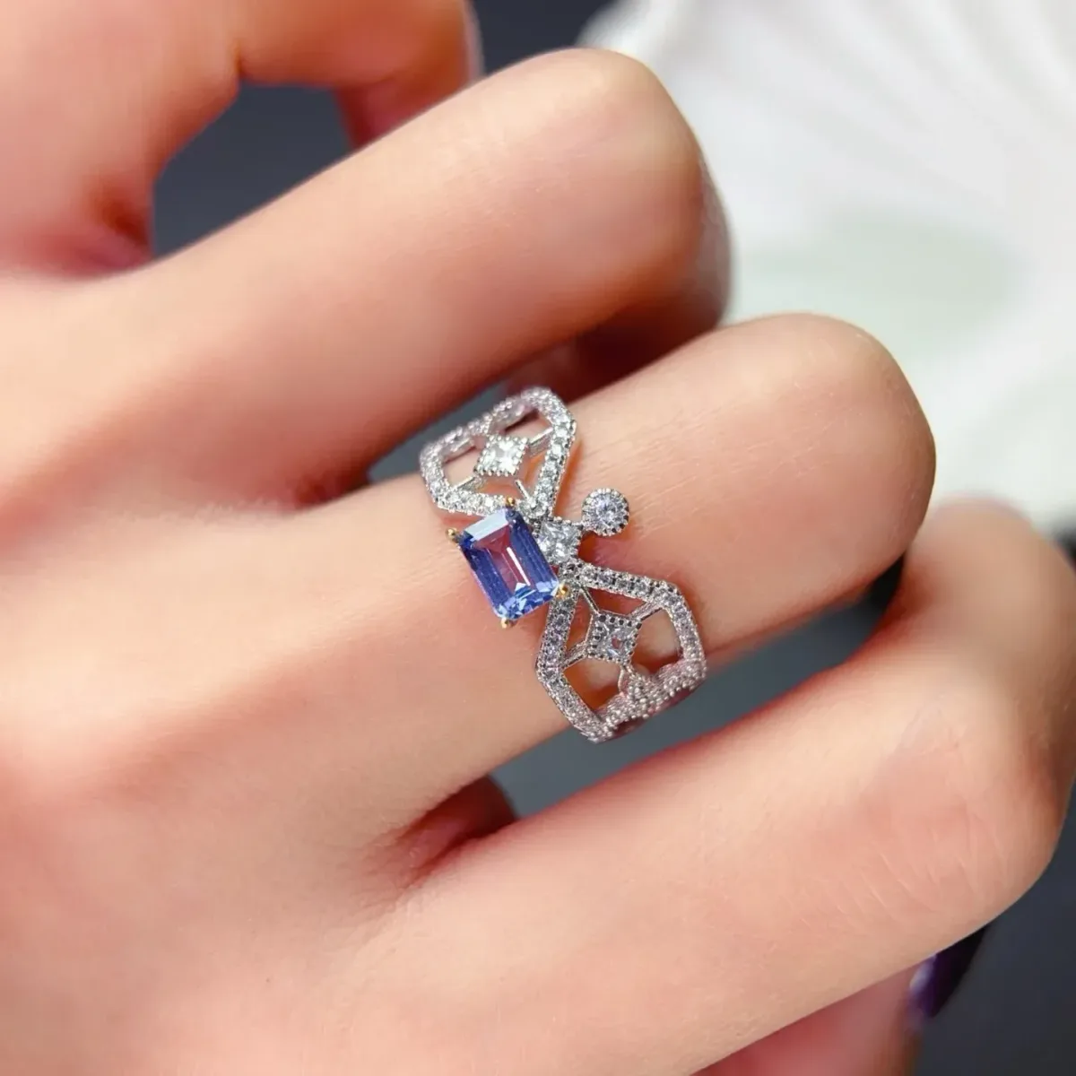 tanzanite ring on the hand for scale