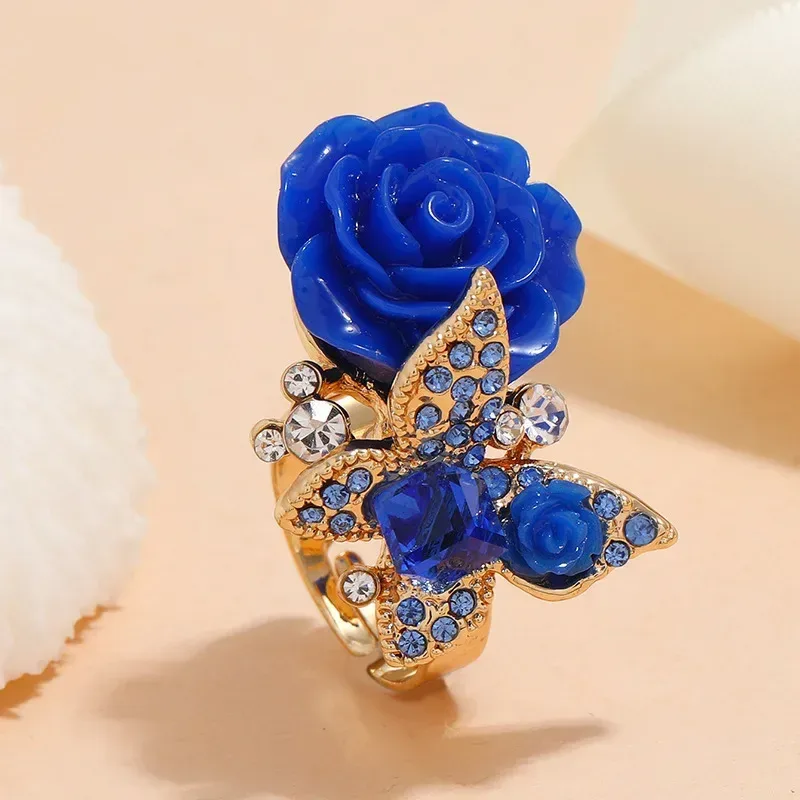 blue rose and butterfly ring with blue centre stone