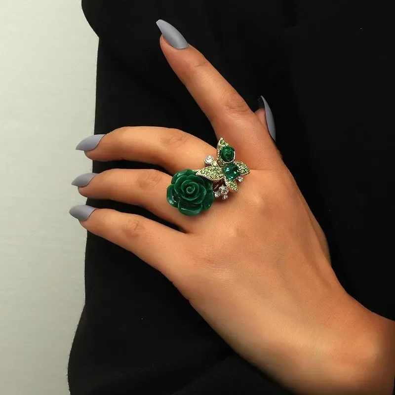 rose and butterfly statement ring worn on a finger